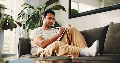 Buy stock photo Man, journal and writing on couch in house, daily reflection or idea notes to relax for creativity. Person, notebook for planning or sketching with agenda in diary, to do list or goal setting in home