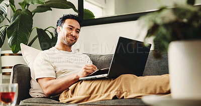 Buy stock photo Happy, freelancer and man with laptop, home and proofreading article on couch and fact check on web. Review, draft and reporter with tech for story, remote work and preparing for publication in house
