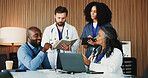 Laptop, notebook and doctors with discussion in hospital for surgery schedule, research or planning. Teamwork, computer and group of healthcare employees in meeting for medical service in clinic.