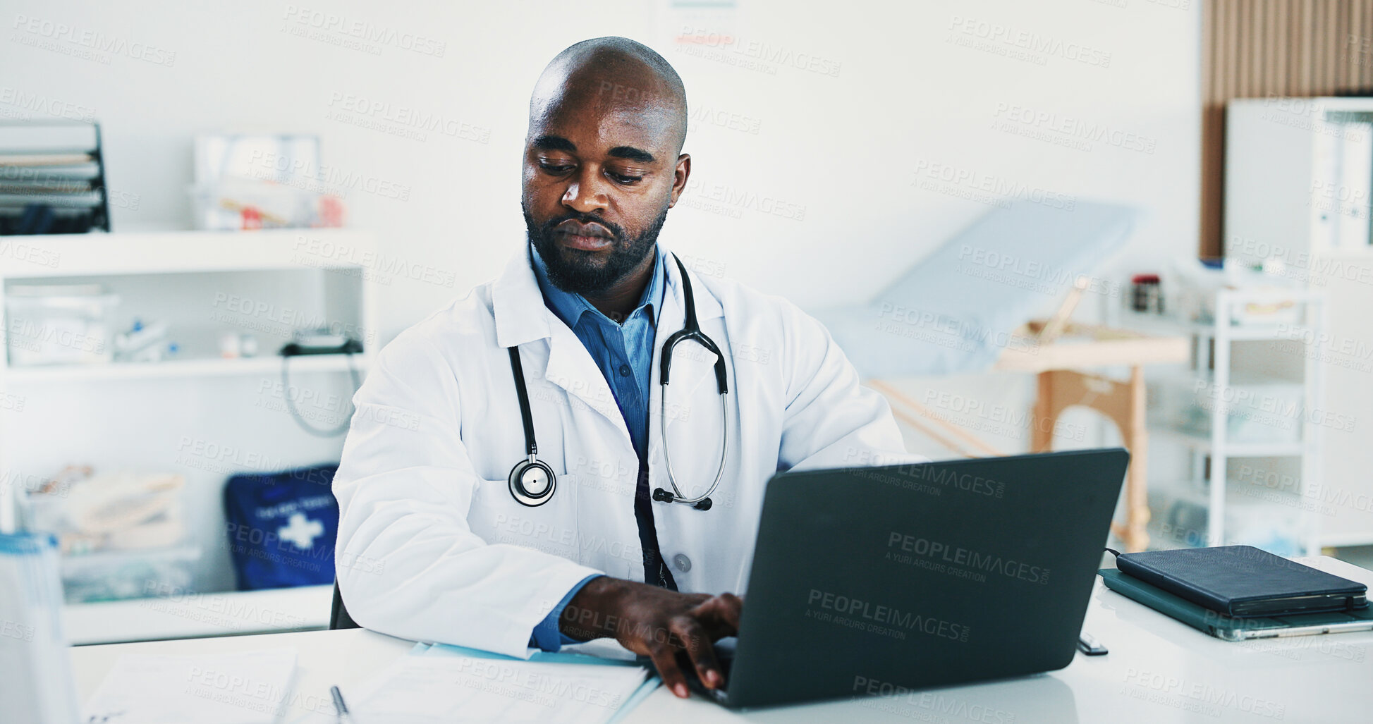 Buy stock photo Doctor, black man and paperwork in office with laptop for health insurance, typing report and review. Healthcare worker, person and reading document in clinic with computer, medical aid and research.