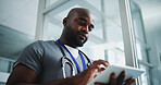 Black man, doctor and reading with tablet in hospital for research, medical report and test results. Below, male person and digital for healthcare history, treatment planning and surgery schedule