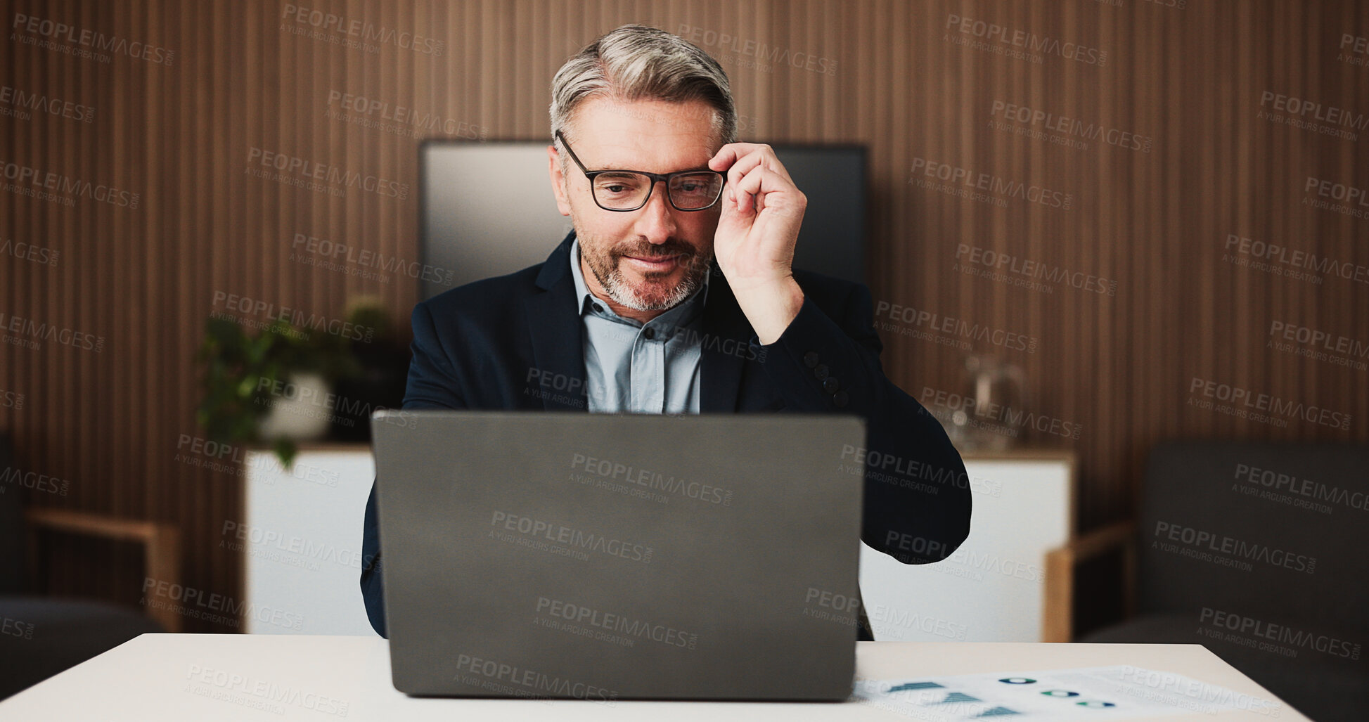 Buy stock photo Reading, research and man with laptop, office and financial analyst with glasses for risk assessment. Online, budget review and mature person with tech for wealth management, graphs and paperwork