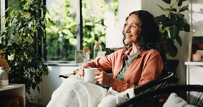 Buy stock photo Home, thinking and woman with coffee, relax and reflection with memory, smile and comfort in lounge. Retirement, remember and mature person with tea, daydreaming and decision with moment and cosy