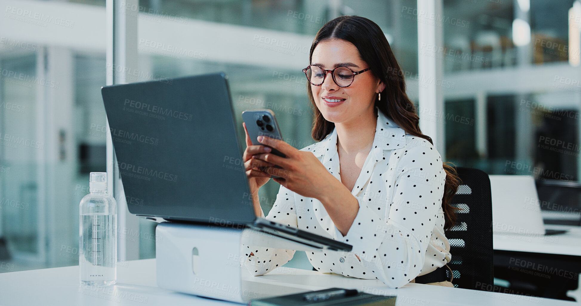 Buy stock photo Business woman, phone and smile with laptop, break and messages as accountant in office. Female person, glasses and tech for finance agency, notifications and investment opportunity for payroll job