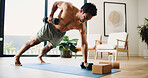 Fitness, man and plank in home with dumbbells for balance exercise, strength training or bodybuilding. Active, person and weights on floor with core engagement for stability, workout and performance.