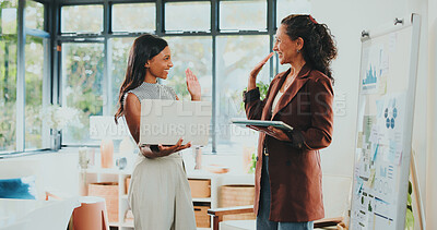 Buy stock photo Creative women, high five and tech for designer agency in office for internship or project management. App, meeting and celebration with woman, mentor and coaching for training conversation or update