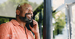 Phone call, happy and black man in home by window for conversation, chatting and connection. Low angle, smile and person on smartphone for communication, contact and speaking for social networking