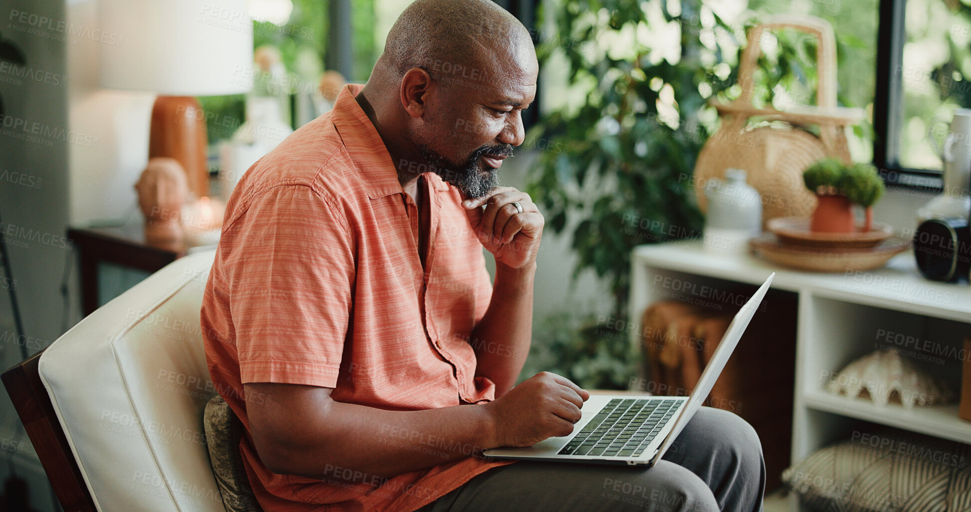 Buy stock photo Remote work, reading or black man in home with laptop, lead update or edit of article. Freelancer, mature person or journalist in living room with technology, fact check or source contact on email.
