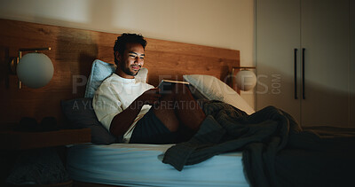 Buy stock photo Tablet, calm and man in bed in home at night for watching movie, series or film for entertainment. Technology, app and male person streaming show online on website in bedroom in evening at house.