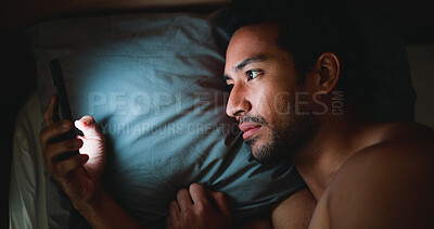 Buy stock photo Night, man and reading in bed with phone for text message reply, social media and check dating site. Late, person and scroll with tech in apartment for online conversation, internet and mobile app.