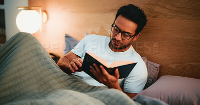 Buy stock photo Reading book, night and man in bed, glasses and entertainment with fiction story. Evening, eyewear and person with novel, house and hobby with cozy activity, literature and comfortable with poetry
