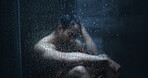 Man, shower and droplets in bathroom for depression, mental health and reflection in home. Male person, house and running water in morning for fear, grief and splash on glass with anxiety or stress
