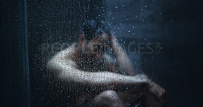 Buy stock photo Man, shower and droplets in bathroom for mental health, reflection or thinking in home. Person with depression, house and running water for fear, grief and glass with anxiety, doubt or stress