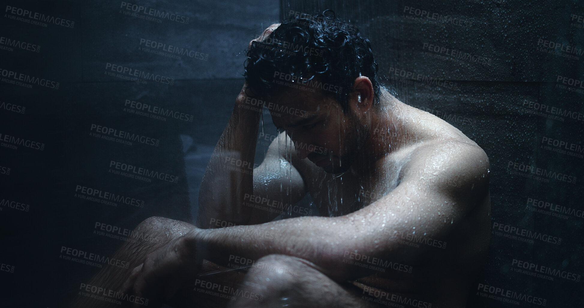 Buy stock photo Man, shower and frustrated in bathroom for grief, mental health and reflection in home. Person with depression, house and running water with emotions, fear and disappointed with anxiety or stress