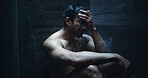 Man, shower and frustrated in bathroom for fear, mental health and reflection in home. Male person, house and running water in morning for depression, grief and splash on glass with anxiety or stress