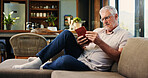 Reading, book and mature man on sofa with glasses, calm and literature hobby on weekend rest. Free time, study and senior person in house with novel, relax and fantasy story on Saturday afternoon.