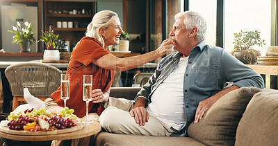 Buy stock photo Anniversary, celebration and senior couple on couch for romantic date, affection or marriage commitment. Home, loyalty or old people with charcuterie board for special day, happiness or feeding fruit