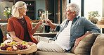 Happy, couple and cheers with champagne, lounge and celebration for anniversary on couch and romance. Home, mature man and woman with alcohol for special day, bonding and toast for commitment or love