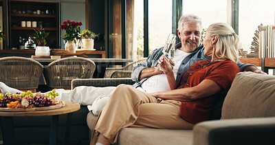 Buy stock photo Couple, love and cheers with champagne, lounge and celebration for anniversary on couch and romance. Happy, mature man and woman with alcohol for special day, home and toast for commitment or bonding