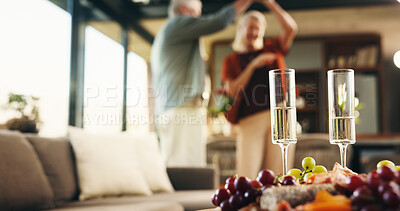 Buy stock photo Charcuterie board, house and old couple with champagne, dancing and bonding together with anniversary. Music, man or woman with food, alcohol and love with celebration, marriage and snack platter