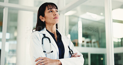 Buy stock photo Thinking, doctor and woman in hospital, arms crossed and contemplation for treatment expert. Medical service, below or mature person in clinic, problem solving or professional with decision or choice