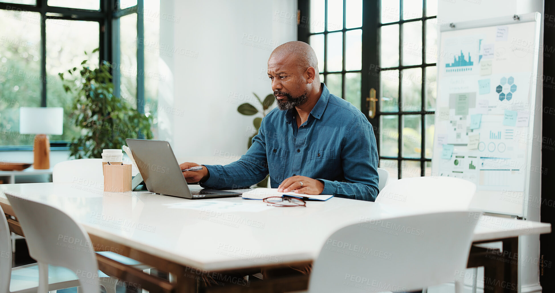 Buy stock photo Laptop, office and business black man with graph for financial review, statistics or budget report. Corporate, planning and person on computer with chart, documents and research for finance analysis