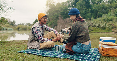 Buy stock photo Smile, couple and picnic with coffee outdoor for travel, warm beverage and trekking adventure. Happy, people and camping with drink for breakfast, romance and bonding together on holiday in nature