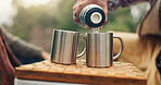 Hands, couple and picnic with coffee outdoor for travel, warm beverage and trekking adventure. People, camping and pouring water for breakfast drink, romance and bonding together on holiday in nature