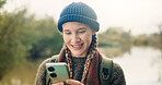 Cellphone, happy and woman in nature for backpacking with online maps for directions on hike trail. Smile, technology and female person with phone for trekking tips on blog on mobile app in forest.