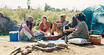 Camping, friends and people in forest, conversation and bonding together with weekend break. Group, women and men in woods, discussion or vacation with getaway trip, relax and campfire with adventure