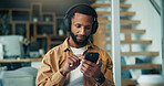 Headphones, reading or black man with phone in office, music listening or motivation podcast for work boost. Mobile, notification or person with audio app for streaming, workplace playlist or radio
