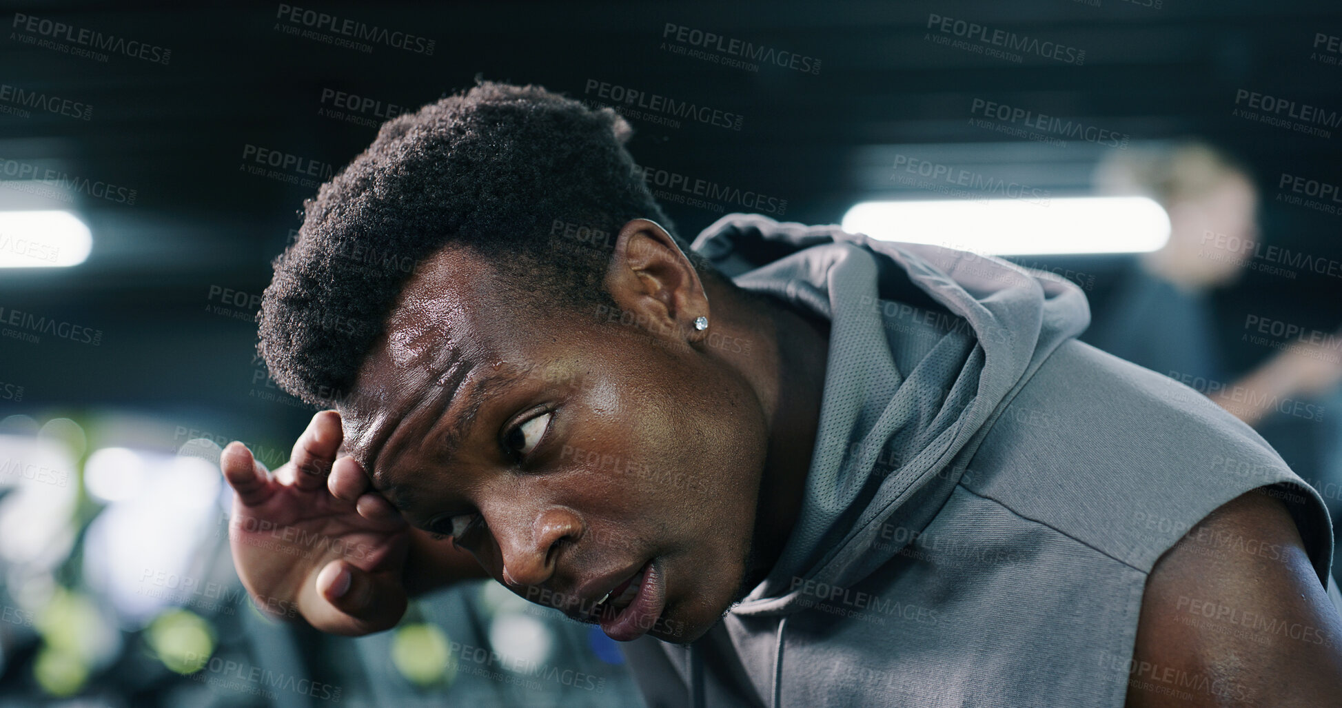 Buy stock photo Sweat, tired and black man in gym for fitness break, wellness and recovery from intense exercise. Serious, fatigue and person in workout club for rest, health and breathing for challenge with bokeh