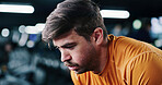 Breathing, fatigue and man in gym for fitness break, wellness and recovery from intense exercise. Sweat, tired and person in workout club for rest, health and resilience for challenge with bokeh