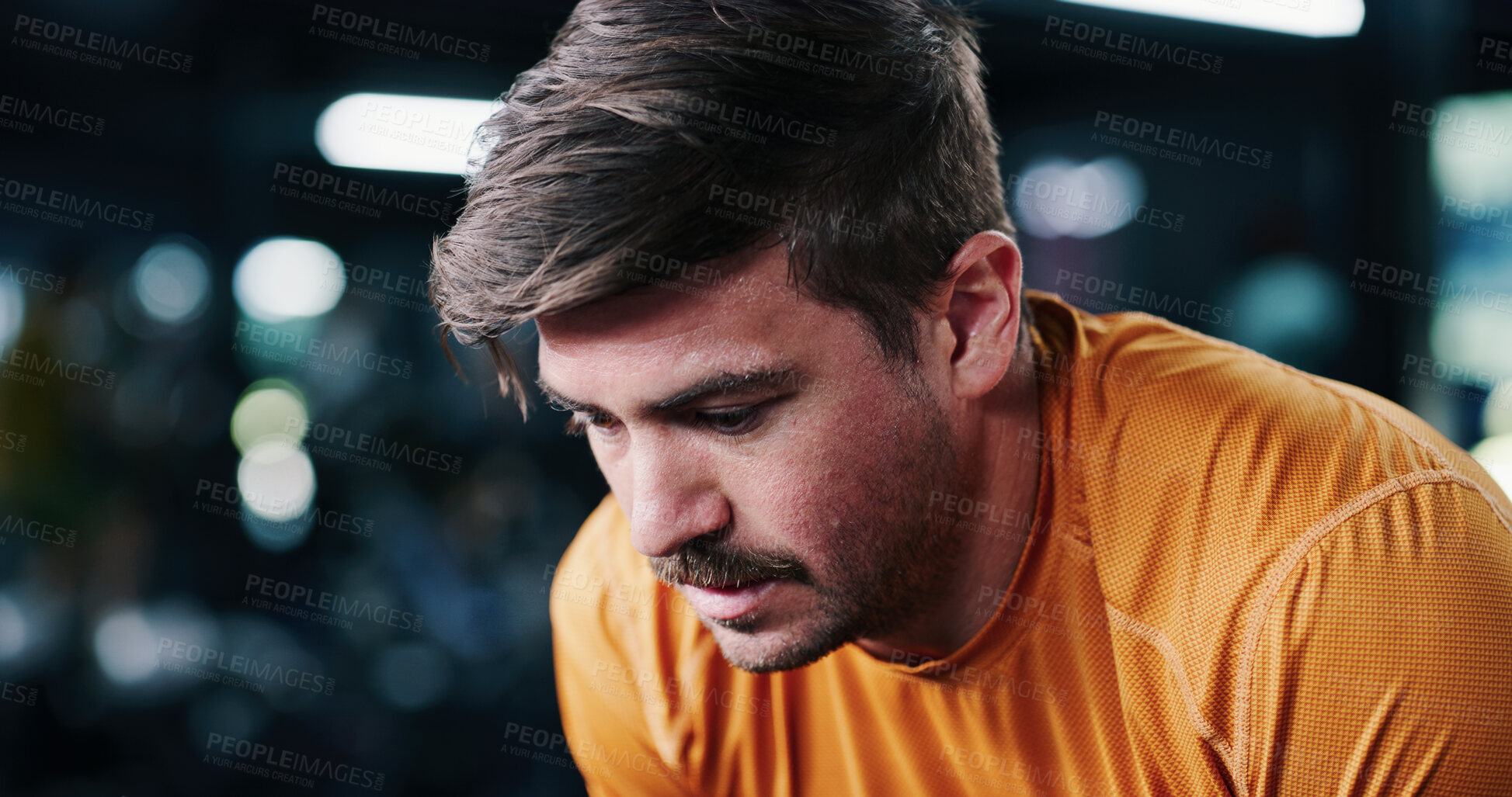 Buy stock photo Breathing, tired and man in gym for fitness break, wellness and recovery from intense exercise. Sweat, fatigue and person in workout club for rest, health and relax after challenge with bokeh