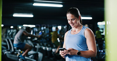 Buy stock photo Fitness, woman and happy with phone at gym for health progress, membership renewal and sign up. People, athlete and smile with mobile app at wellness club to track workout or exercise break at night