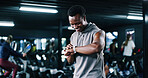 Fitness, smile and watch with man in gym for performance tracking, results or satisfaction. Exercise, space and time with happy person in health club for challenge, improvement or training review