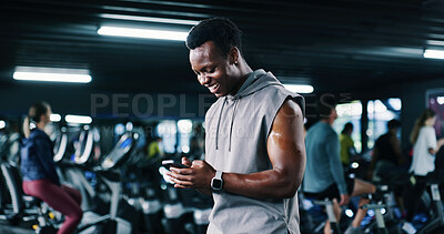 Buy stock photo Fitness, man and happy with phone at gym for workout progress, membership renewal and sign up. People, athlete and smile with mobile app at night for exercise performance, training break and results
