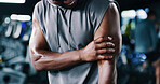 Arm, fitness and injury with man in gym for muscle fatigue, training accident or workout mistake. Bicep, exercise and inflammation with person in health club for condition, cramp or emergency