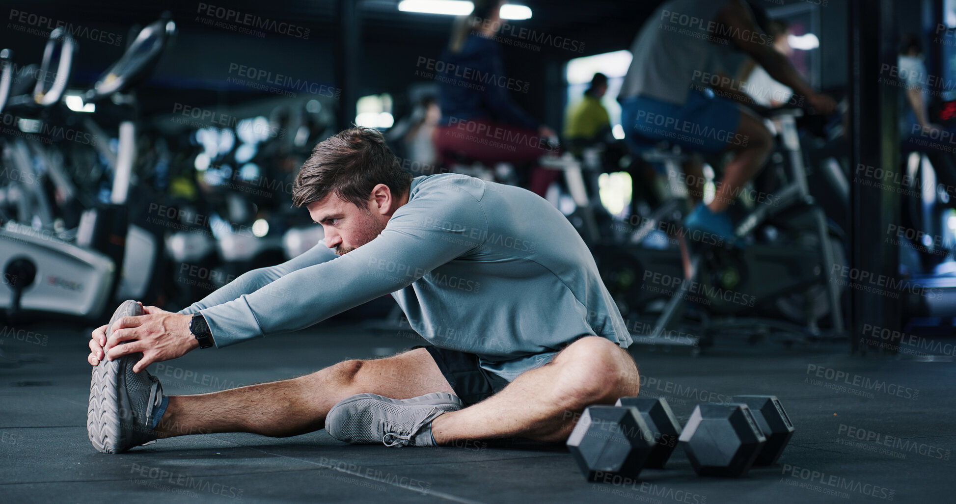 Buy stock photo Man, stretching or gym with leg on floor for workout preparation, exercise or indoor training. Active, male person or getting ready with warm up or dumbbells for flexibility or fitness in health club