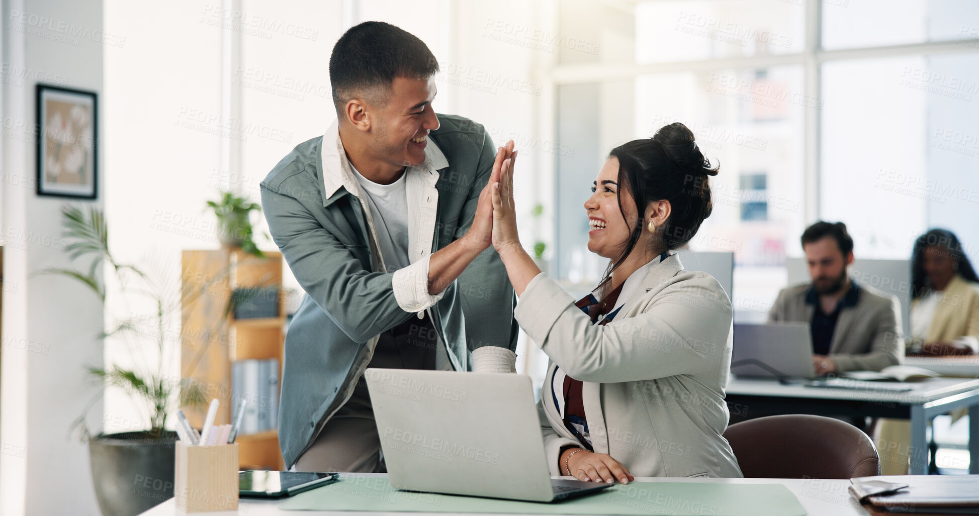 Buy stock photo Celebration, high five and laptop with designer people in office together for bonus or motivation. Computer, design and success with happy employee team at desk in workplace for goals or target