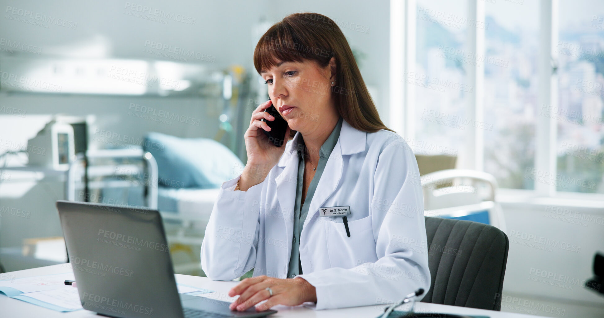 Buy stock photo Clinic, doctor and woman with laptop, phone call or discussion with contact for appointment schedule. Hospital, telehealth and mature person with tech for communication, online and medical diagnosis