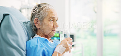 Buy stock photo Thinking, water and senior woman in hospital bed for healing, recovery and drinking for wellness. Healthcare, thoughtful and elderly patient resting for surgery, diagnosis and liquid for medicine