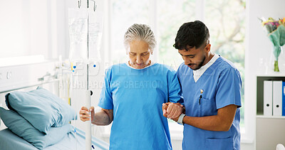 Buy stock photo Physiotherapist, senior woman and support for walking, help and holding hands with IV drip at hospital. Man, elderly patient and care for recovery, injury or rehabilitation with steps at clinic
