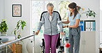 Woman, senior patient or physiotherapist with walker rail for balance or stability in clinic. Elderly, female person or health physio with assistance for muscle recovery or movement in practice