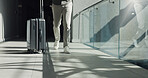 Business person, legs and walking with suitcase for travel, work commute or job opportunity. Traveler, employee or moving with luggage for company trip, schedule flight or career journey in building