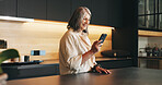 Home, smartphone and woman in kitchen, smile and message to contact, texting or email. Happy, mobile user or mature person with cellphone, online reading or digital app for social media or connection