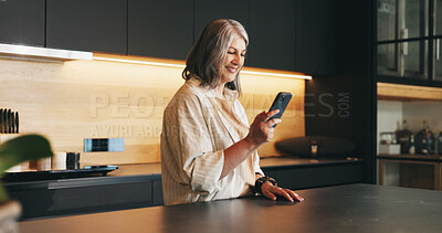 Buy stock photo Home, smartphone and woman in kitchen, smile and message to contact, texting or email. Happy, mobile user or mature person with cellphone, online reading or digital app for social media or connection