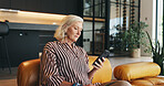 Phone, relax and senior woman on sofa in home with networking, communication or texting on mobile app. Technology, reading and elderly female person in retirement with cellphone for chatting in house