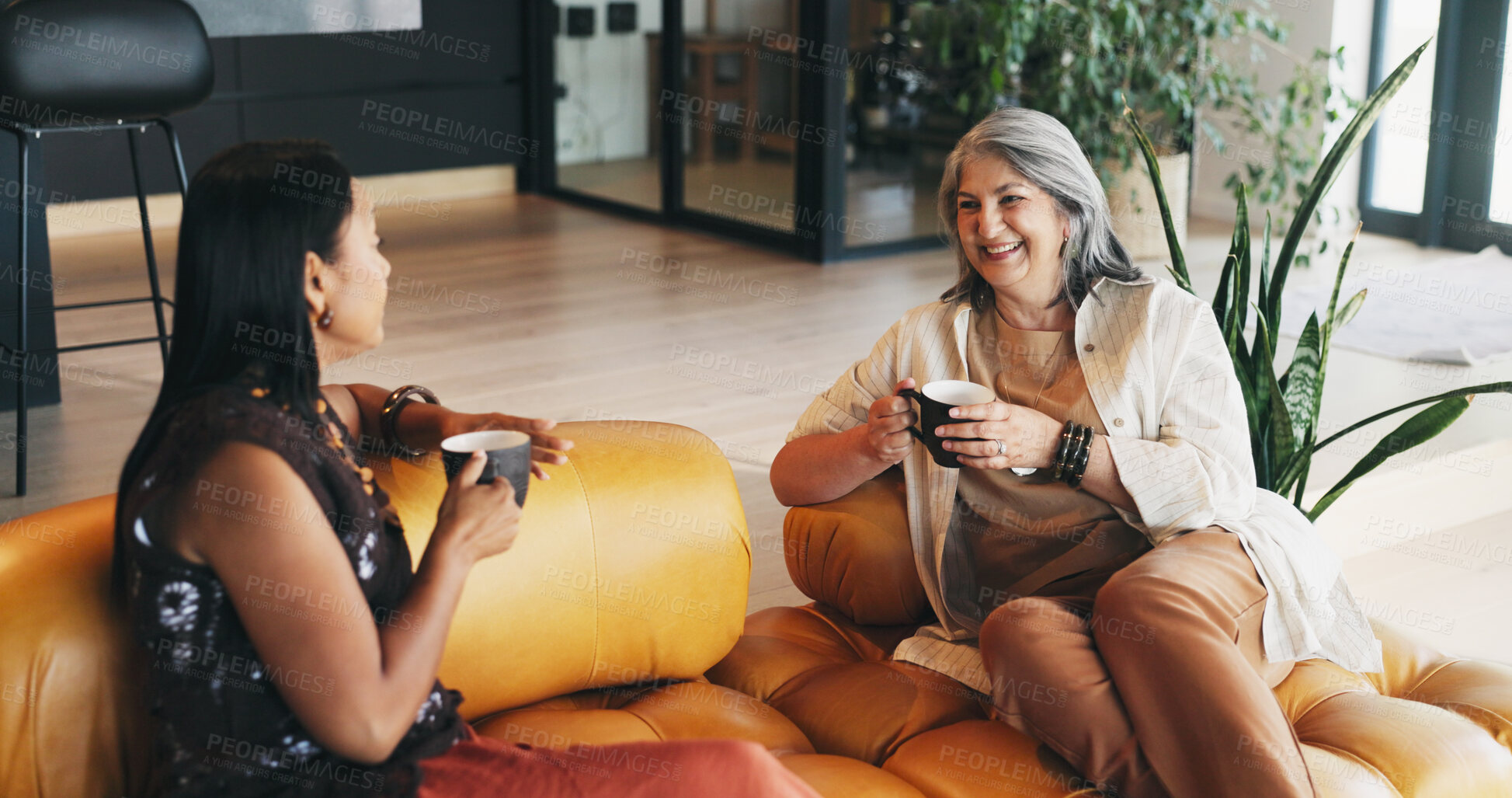 Buy stock photo Tea, mature women and friends in living room for conversation, gossip or bonding together on weekend. Happy people, talking and relax with coffee on sofa in home for catch up, story and advice