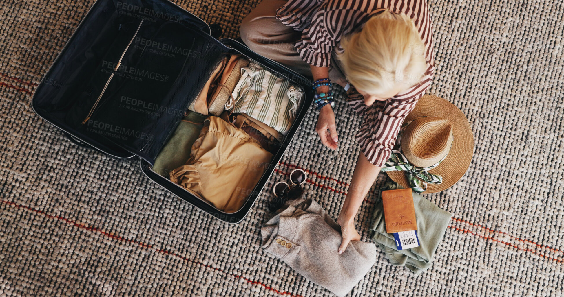 Buy stock photo Woman, travel and packing with suitcase in home above for holiday, vacation or getaway. Top view, female person or traveler with clothing, luggage or passport ticket for preparation or flight booking